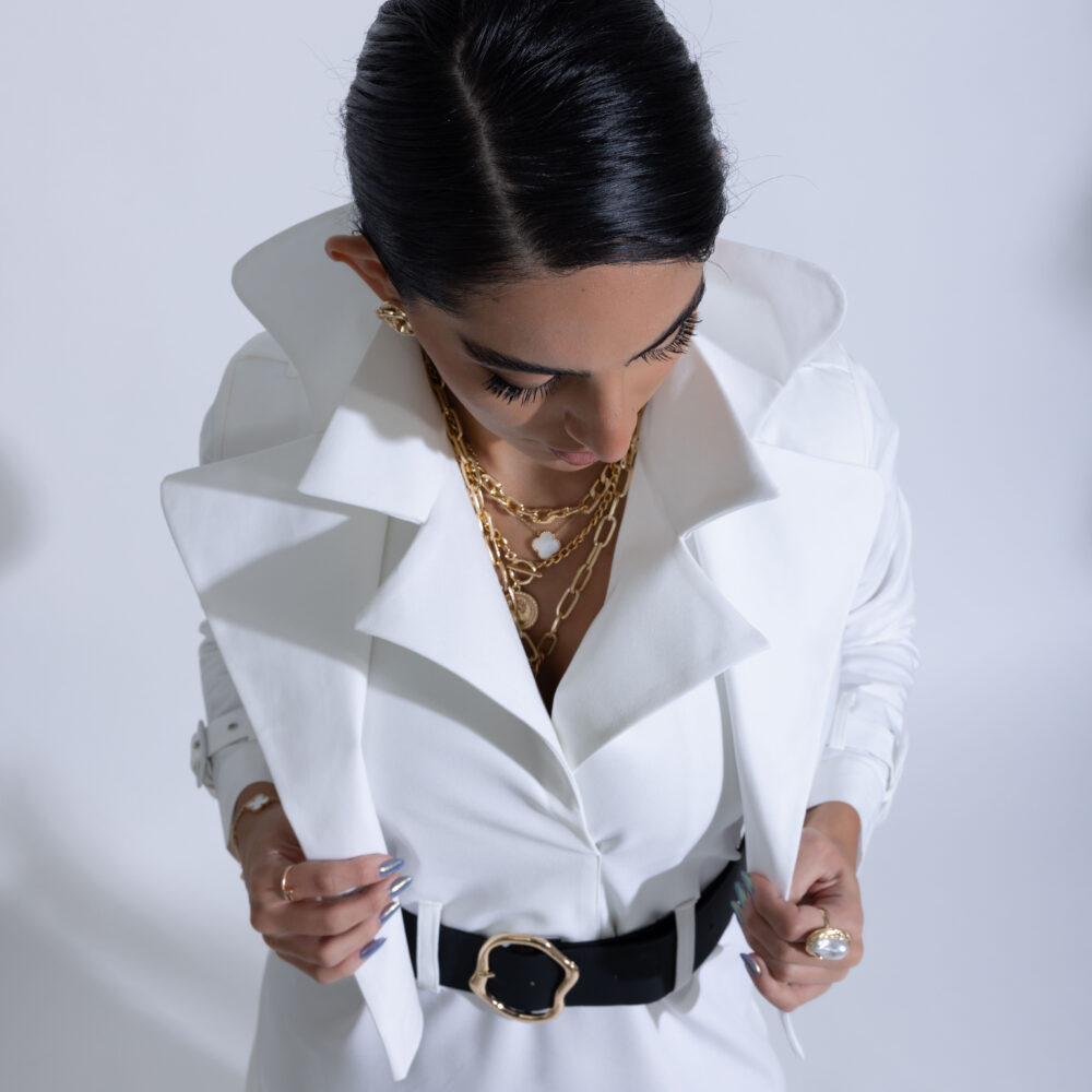 Elegant model posing in high fashion dress and luxury accessories during a professional photoshoot in Kuwait.