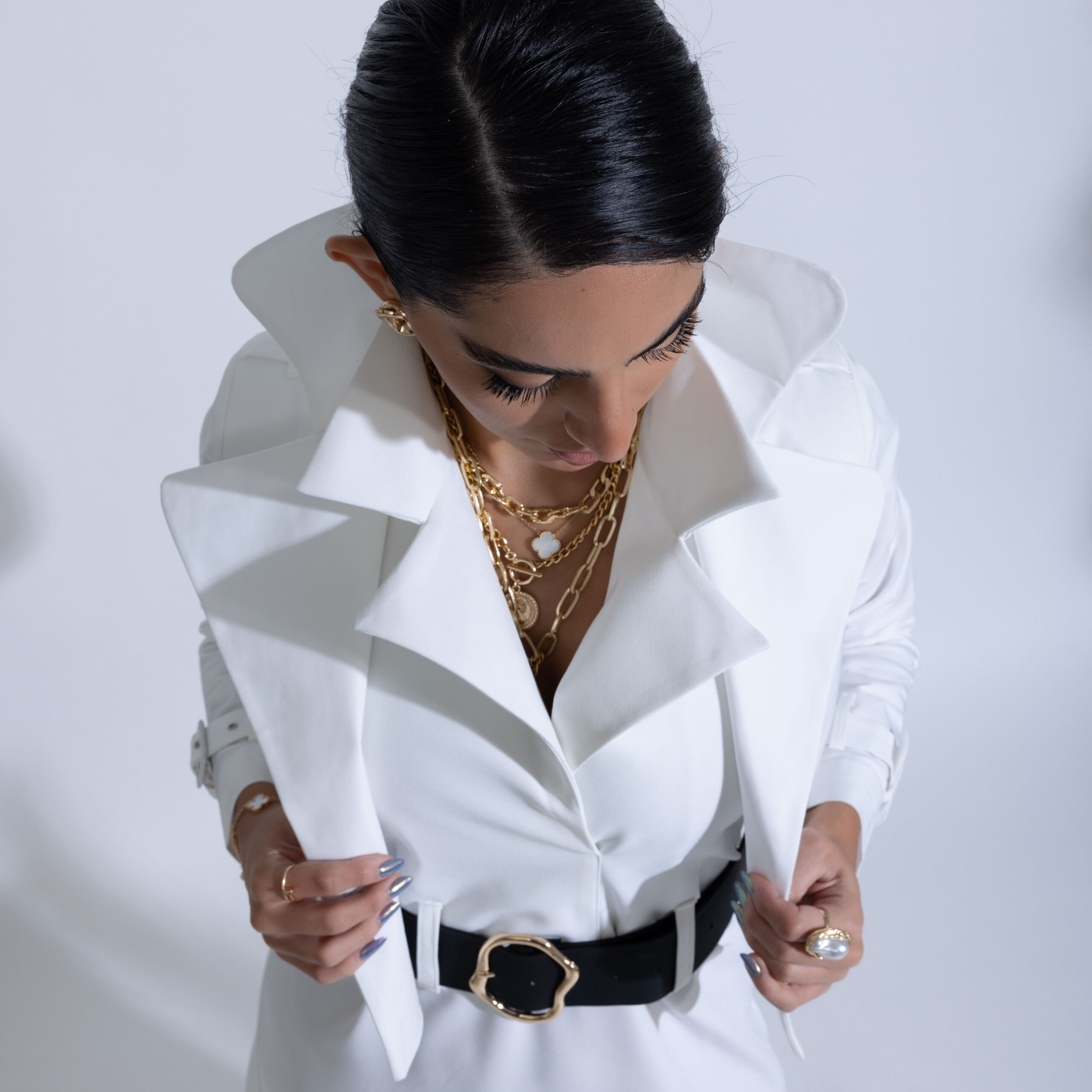 Elegant model posing in high fashion dress and luxury accessories during a professional photoshoot in Kuwait.