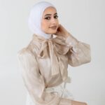 A hijabi model from Kuwait posing in a photo studio setting.
