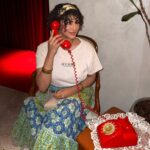 Model with red telephone.
