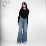 Female model in casual outfit with long sleeves and denim jeans