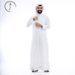Full-length shot of a smiling man in Kuwaiti traditional Dishdasha and Gathra