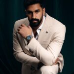 Man in beige suit posing confidently