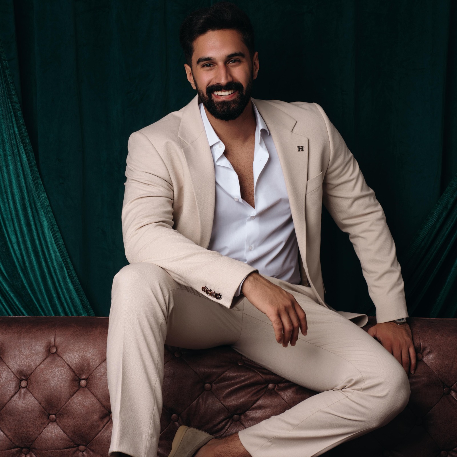 Man with beard in beige suit