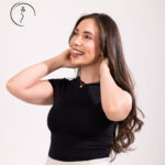 Smiling woman in black top looking up.