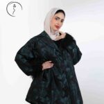 Studio portrait of a Kuwaiti woman wearing a hijab and modest outfit