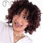 Woman with curly hair making a playful face.