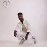 Confident man posing in casual white clothes.