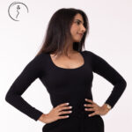 A female model in a black shirt looking to the side.