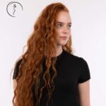 A red-haired woman looking off to the side.